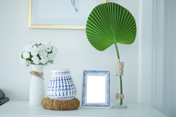 Home interior poster with vertical blue and white metal frame and succulents on white wall background