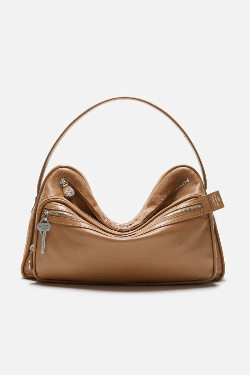 Caramel brown Acne Studios Camero camera shoulder bag in the official studio photograph