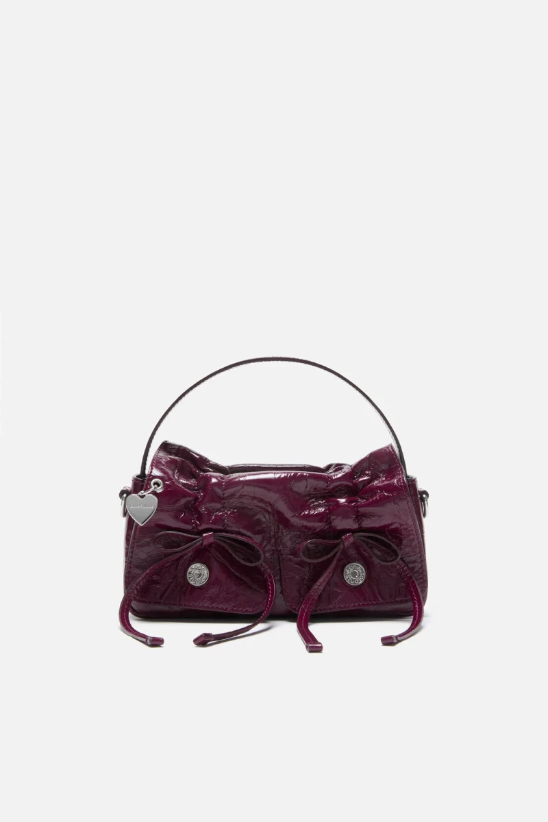 Berry pink Acne Studios multipocket micro bag in the official studio photograph