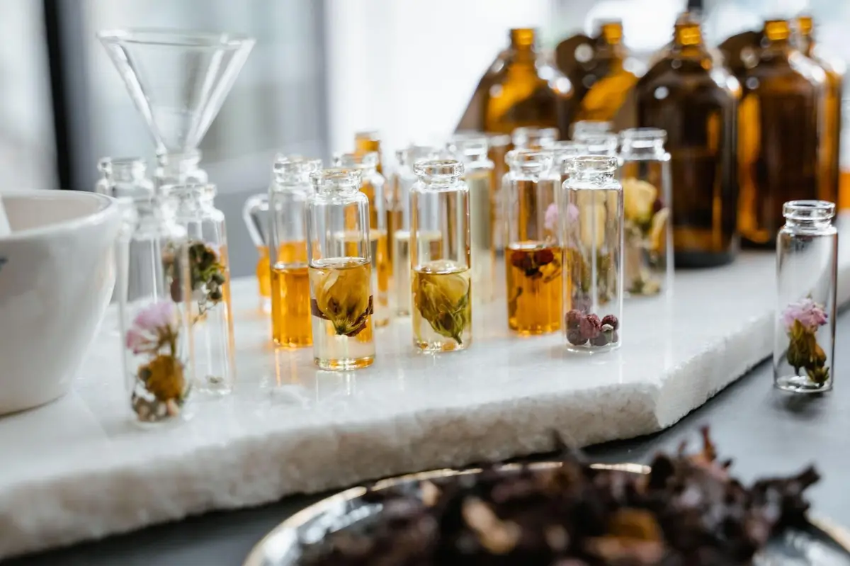Botanical extract vials and dried flowers on marble representing cosmetic ingredient safety and EU formulation standards