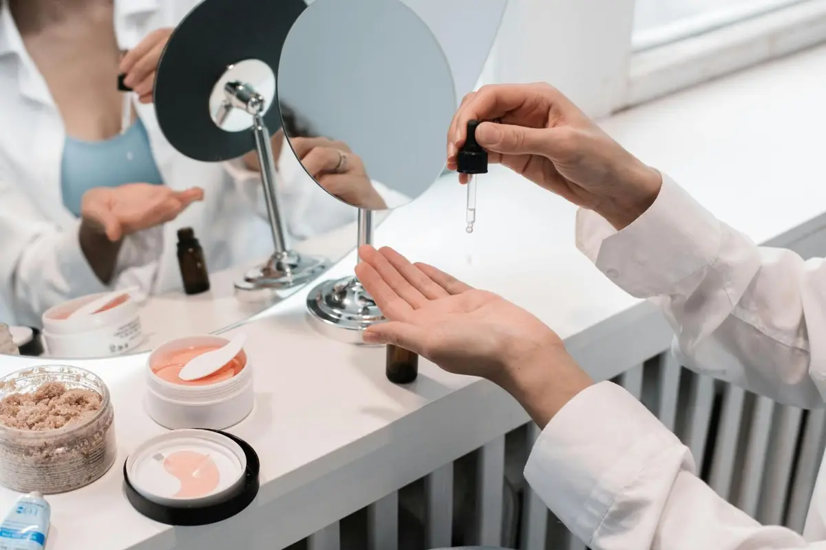 Person carefully applying a skincare serum representing informed consumer choices beyond cosmetic marketing claims