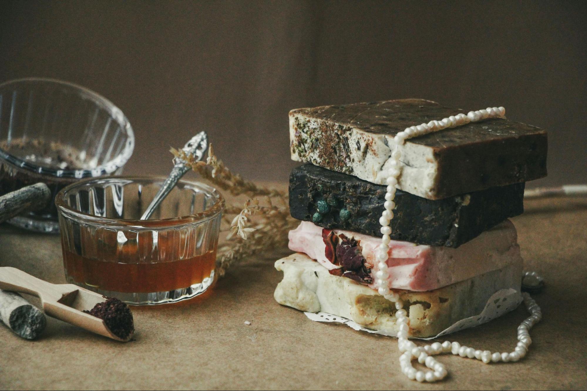 Stack of artisan handmade soaps with botanical ingredients representing European organic certified cosmetic production