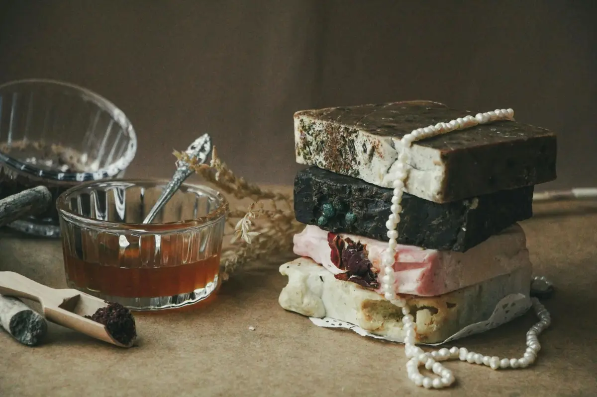 Stack of artisan handmade soaps with botanical ingredients representing European organic certified cosmetic production