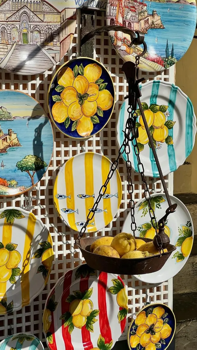 Italian hand-painted ceramic plates at an Amalfi Coast market — European craftsmanship and local production