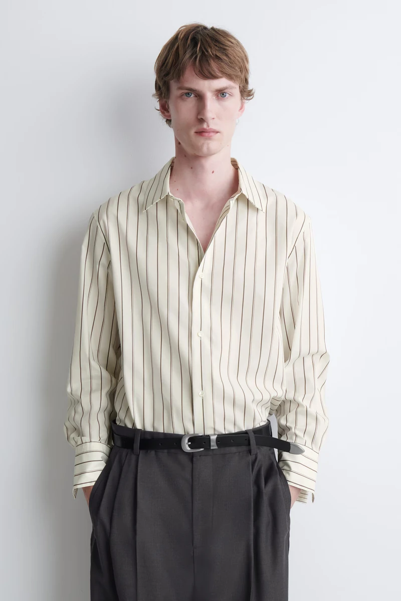 White and brown striped COS cotton-silk shirt worn by a model