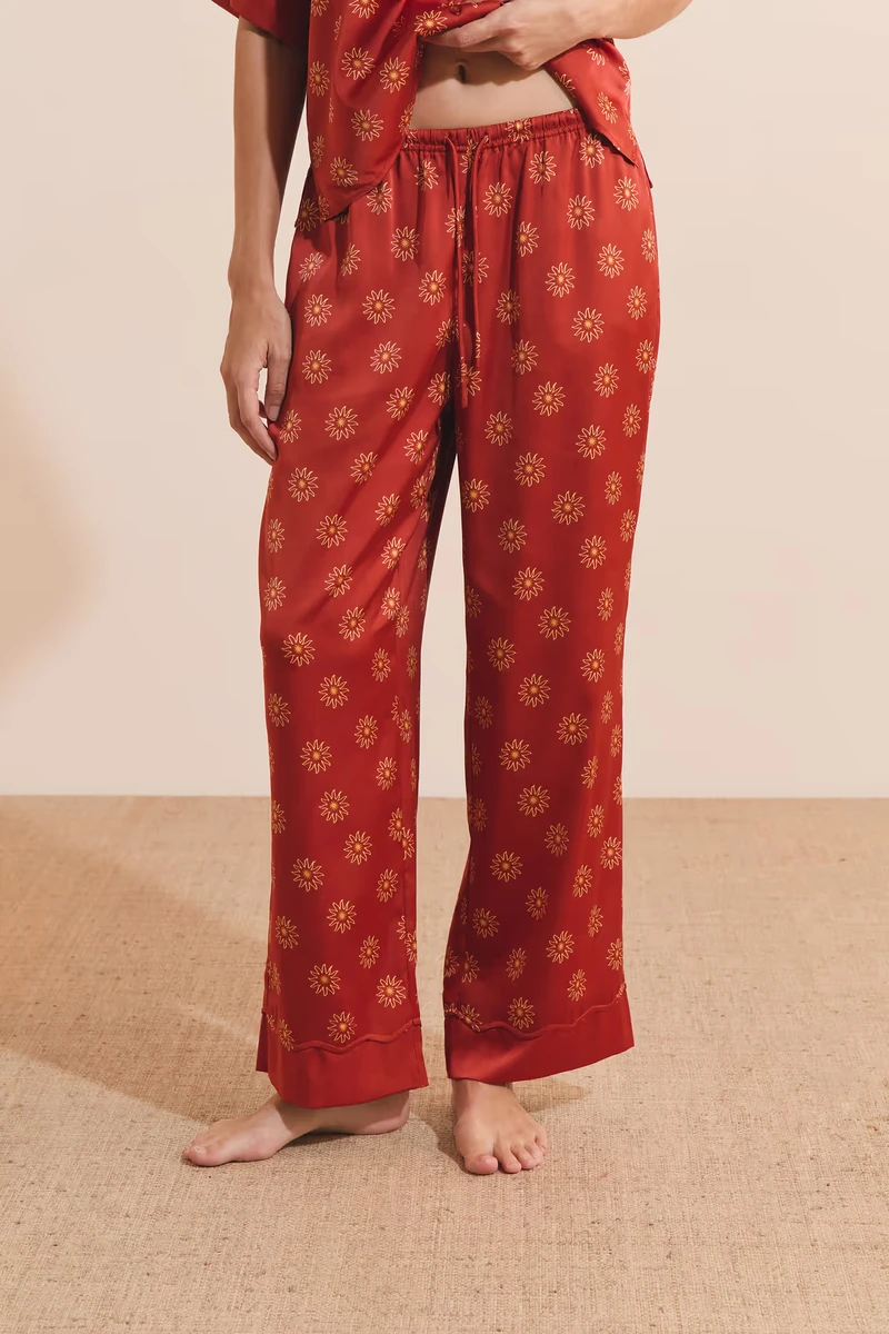 Red patterned Etam satin pajama pants on a model