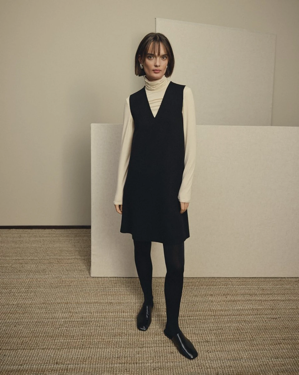 Black MSCH Copenhagen Agatha East sleeveless dress worn over a light top