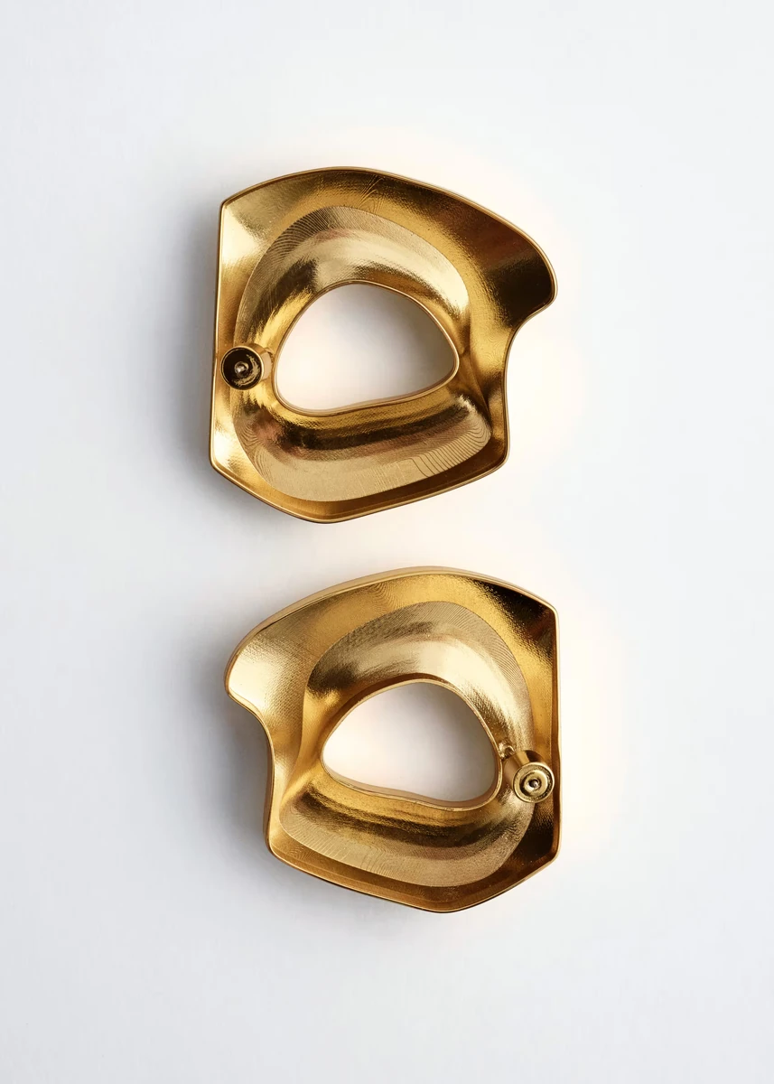 Gold sculptural brass earrings in the official & Other Stories product photograph
