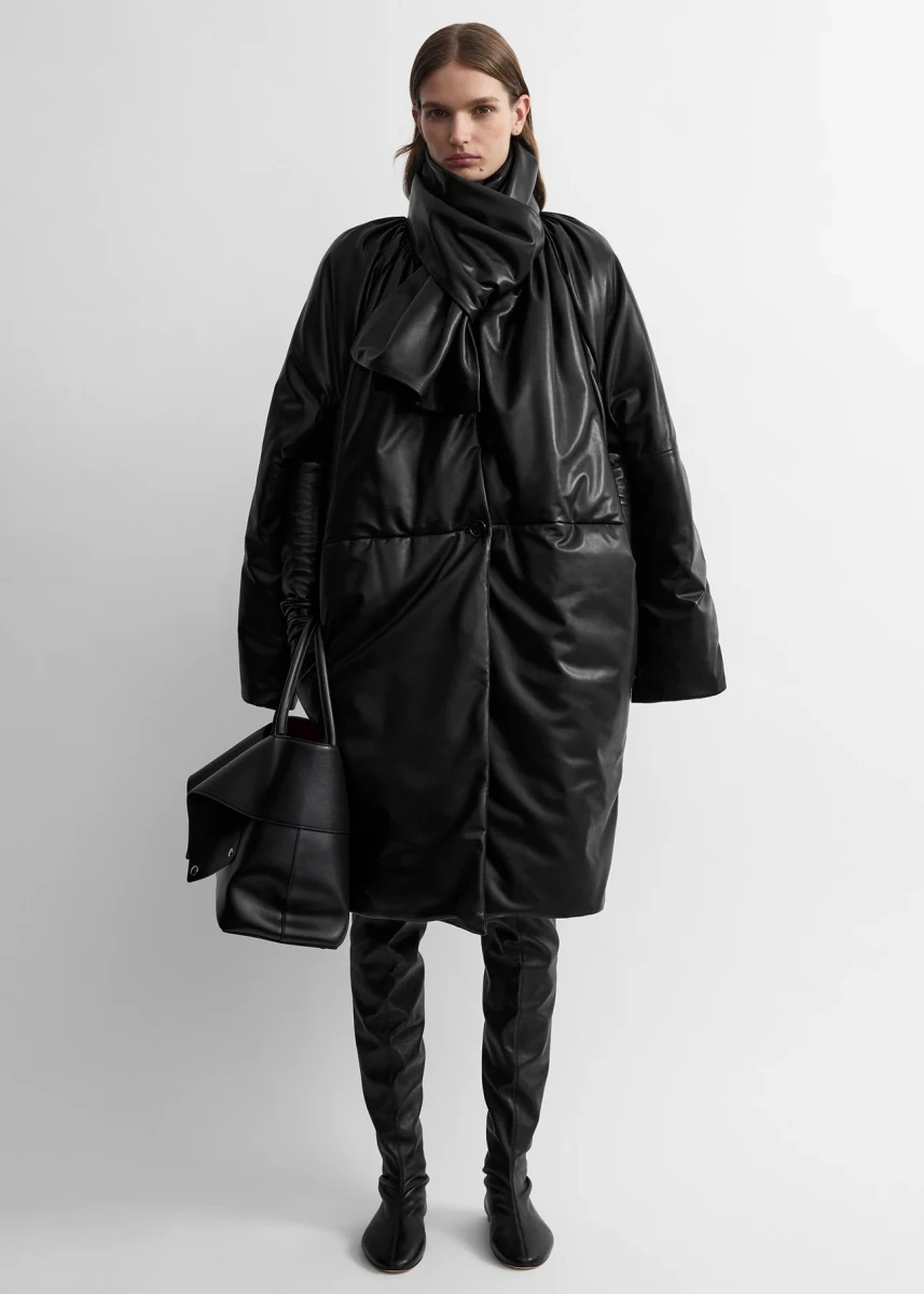 Black TOTEME padded leather coat shown on a model in the official product photograph